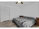 Cozy bedroom with wood-look flooring, a ceiling fan, and neutral décor; ample closet space at 3754 W Hearn Rd, Phoenix, AZ 85053