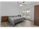 Bright bedroom with wood-look floors and sliding glass doors leading to the backyard and bench at 3754 W Hearn Rd, Phoenix, AZ 85053