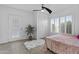 Bedroom with closet, tiled floors, white walls, window, and door to the exterior; bright, neutral space at 3754 W Hearn Rd, Phoenix, AZ 85053