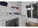 Efficient laundry room with modern washer and dryer; includes a bathroom with dark tile and a shower at 3754 W Hearn Rd, Phoenix, AZ 85053