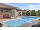 Inviting backyard pool with covered patio, bbq, lounge chairs, and outdoor dining area at 3754 W Hearn Rd, Phoenix, AZ 85053
