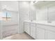 Bathroom featuring double sinks with a large mirror and view into the bedroom at 3815 S 64Th Ln, Phoenix, AZ 85043