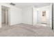 Spacious bedroom with neutral carpet, paint, and natural light streaming in from a large window at 3815 S 64Th Ln, Phoenix, AZ 85043