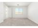Clean, bright bedroom features neutral carpet and paint, with natural light streaming in at 3815 S 64Th Ln, Phoenix, AZ 85043
