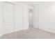 Bright bedroom featuring neutral carpet, white walls, closet with sliding doors and interior door at 3815 S 64Th Ln, Phoenix, AZ 85043