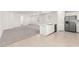 Open concept kitchen with stainless steel appliances, bright white cabinets and tile flooring at 3815 S 64Th Ln, Phoenix, AZ 85043