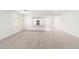 Spacious, bright living room with neutral carpet, white walls, and natural light from a large window at 3815 S 64Th Ln, Phoenix, AZ 85043