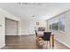 Bright dining room with wood floors, a dining table, and a large window offering plenty of natural light at 3944 W Wilshire Dr, Phoenix, AZ 85009