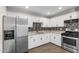 Well-equipped kitchen with stainless steel appliances and white cabinetry at 3944 W Wilshire Dr, Phoenix, AZ 85009