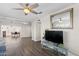 Bright living room featuring sleek flooring, ceiling fan, and mirror above a glass console at 3944 W Wilshire Dr, Phoenix, AZ 85009