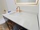Close-up on a vanity with gold hardware and a white marble countertop in a bright bathroom at 4039 E Paradise Dr, Phoenix, AZ 85028