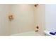 Bright bathroom featuring tiled walls, and gold fixtures, offering a clean and modern look at 4039 E Paradise Dr, Phoenix, AZ 85028