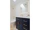 This bathroom features gold hardware, a lighted mirror, and white marbled tiling at 4039 E Paradise Dr, Phoenix, AZ 85028