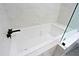 A bright bathroom features a white soaking tub in a shower with glass enclosure and black hardware at 4039 E Paradise Dr, Phoenix, AZ 85028