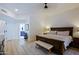Comfortable bedroom with a large bed, bench, and view to the bathroom at 4039 E Paradise Dr, Phoenix, AZ 85028