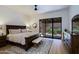Spacious main bedroom with large window overlooking a beautifully landscaped outdoor area at 4039 E Paradise Dr, Phoenix, AZ 85028