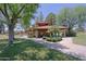 Charming cabana area with a red tile roof surrounded by lush green trees and lawns near the pool at 4039 E Paradise Dr, Phoenix, AZ 85028