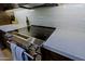 Close up on a stainless steel cooktop with white backsplash and light countertops at 4039 E Paradise Dr, Phoenix, AZ 85028