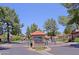 Community entrance featuring lush landscaping, a guard house, and street view at 4039 E Paradise Dr, Phoenix, AZ 85028