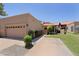 Inviting beige single story home featuring a two car garage and well manicured lawn at 4039 E Paradise Dr, Phoenix, AZ 85028