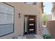 Stylish front door with modern design and complementary sidelight window at 4039 E Paradise Dr, Phoenix, AZ 85028