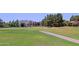 Scenic view of the golf course with lush green fairways, trees, and distant mountains at 4039 E Paradise Dr, Phoenix, AZ 85028