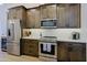 Well-equipped kitchen featuring stainless steel appliances and dark wood cabinets at 4039 E Paradise Dr, Phoenix, AZ 85028