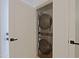 Compact laundry closet contains stacked washer and dryer units, maximizing space at 4039 E Paradise Dr, Phoenix, AZ 85028