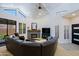 Bright living room featuring vaulted ceilings, clerestory windows and a comfortable leather wraparound sofa at 4039 E Paradise Dr, Phoenix, AZ 85028