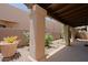 Charming covered patio with stone columns, decorative gravel, and mature plants at 4039 E Paradise Dr, Phoenix, AZ 85028