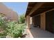 Inviting covered patio with decorative stone columns and lush greenery at 4039 E Paradise Dr, Phoenix, AZ 85028