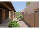 Cozy patio area featuring lush rose bushes and desert landscaping, perfect for outdoor relaxation at 4039 E Paradise Dr, Phoenix, AZ 85028