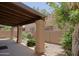 Inviting covered patio with stone columns and vibrant greenery, ideal for outdoor entertaining at 4039 E Paradise Dr, Phoenix, AZ 85028