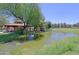 Scenic pond with fountain and views of gazebo surrounded by mature trees at 4039 E Paradise Dr, Phoenix, AZ 85028