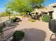 Serene backyard features desert landscaping, mature trees, and privacy wall, perfect for outdoor relaxation at 4102 E Rancho Tierra Dr, Cave Creek, AZ 85331