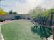 Well-manicured backyard with artificial turf and desert landscaping providing a serene outdoor space at 4102 E Rancho Tierra Dr, Cave Creek, AZ 85331