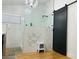 A renovated bathroom features a glass-enclosed shower, black hardware, and modern lighting fixtures at 4102 E Rancho Tierra Dr, Cave Creek, AZ 85331