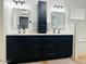 Bathroom features a double vanity with black cabinets, a tower cabinet, and a white countertop at 4102 E Rancho Tierra Dr, Cave Creek, AZ 85331