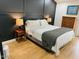 Cozy bedroom with hardwood floors, neutral bedding, lamps, and a chest of drawers at 4102 E Rancho Tierra Dr, Cave Creek, AZ 85331