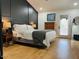 Comfortable bedroom with a dark accent wall, neutral bedding, and natural light from the window at 4102 E Rancho Tierra Dr, Cave Creek, AZ 85331