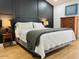 Comfortable bedroom with hardwood floors, neutral bedding, lamps, and a chest of drawers at 4102 E Rancho Tierra Dr, Cave Creek, AZ 85331