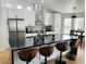 Stylish kitchen featuring a center island with bar stools, white cabinetry, and modern lighting fixtures at 4102 E Rancho Tierra Dr, Cave Creek, AZ 85331