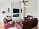 Cozy living room with a fireplace, comfortable seating, and stylish lighting at 4102 E Rancho Tierra Dr, Cave Creek, AZ 85331