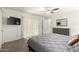 Main bedroom with carpet, ceiling fan, and neutral walls offering lots of natural light at 4102 W Bluefield Ave, Glendale, AZ 85308