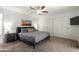 Bedroom featuring a ceiling fan, large closet, neutral walls, and an ensuite bathroom at 4102 W Bluefield Ave, Glendale, AZ 85308