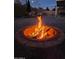 Inviting backyard fire pit set in a cozy outdoor area with paver stones and privacy fence at 4102 W Bluefield Ave, Glendale, AZ 85308