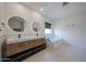 Elegant bathroom featuring a modern vanity with dual sinks and a soaking tub at 4202 E Catalina Dr, Phoenix, AZ 85018