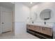 Well-lit bathroom with a double sink vanity, modern faucets and subway tile accents at 4202 E Catalina Dr, Phoenix, AZ 85018