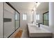 Modern bathroom with double vanity sinks and a walk-in shower behind a glass door at 4202 E Catalina Dr, Phoenix, AZ 85018