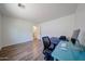 Spacious bedroom featuring wood floors, white walls, and a work area perfect for a home office at 4202 E Catalina Dr, Phoenix, AZ 85018